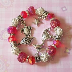 Red bead bracelet with Beach charms